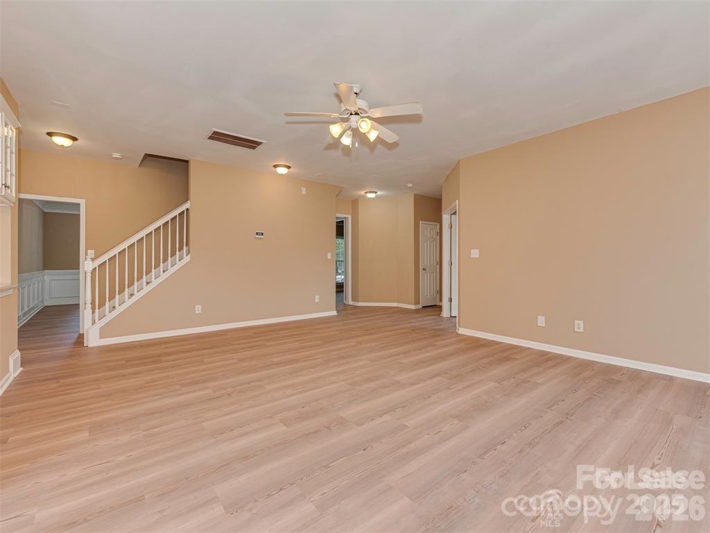 5607 Fulton Ridge Drive Indian Trail, NC 28079 - Photo 12 of 44 a view of an empty room with wooden floor and a ceiling fan
