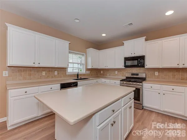 a kitchen with a white cabinets and white appliances