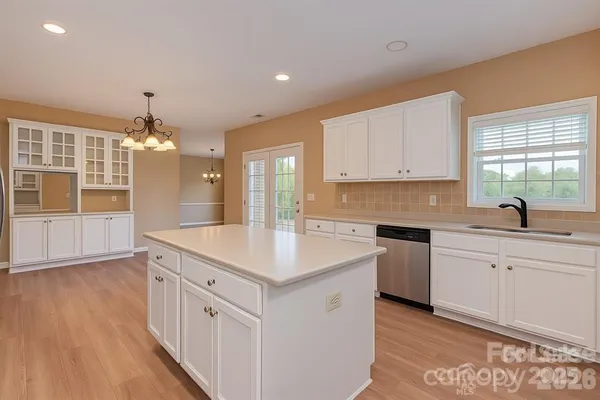 a kitchen that has a sink and a stove in it