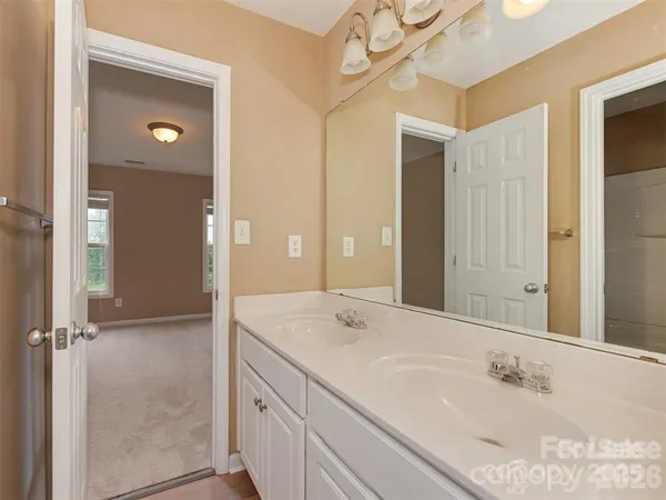 a bathroom with a double vanity sink and a mirror