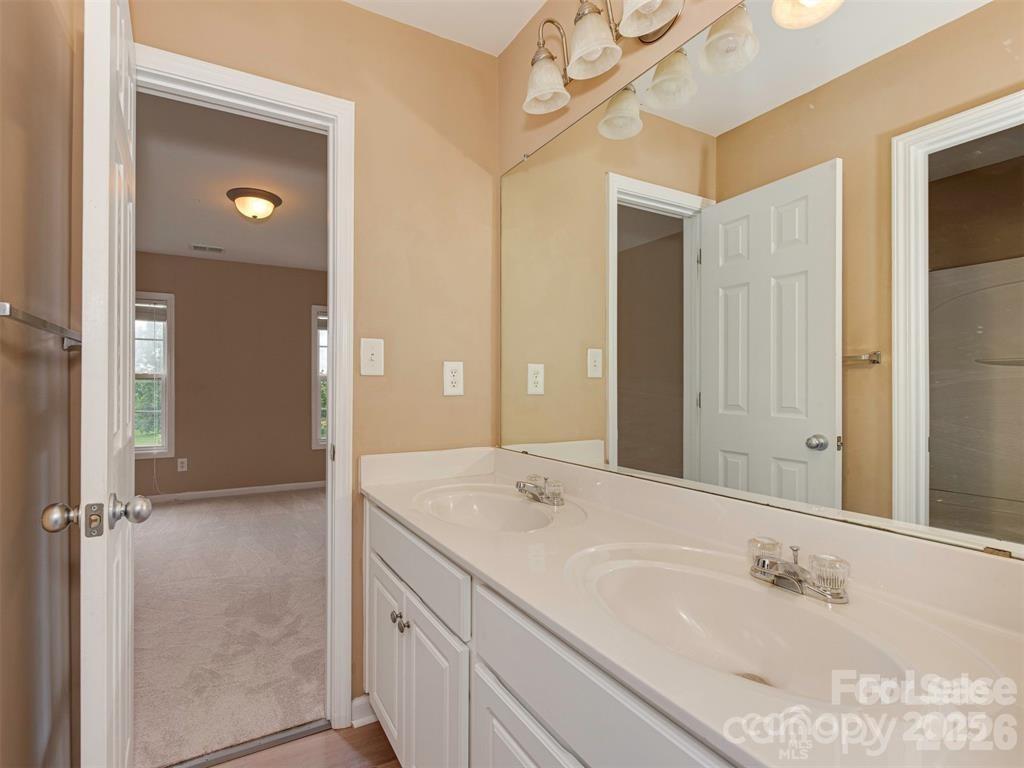 5607 Fulton Ridge Drive Indian Trail, NC 28079 - Photo 23 of 44 a bathroom with a double vanity sink and a mirror