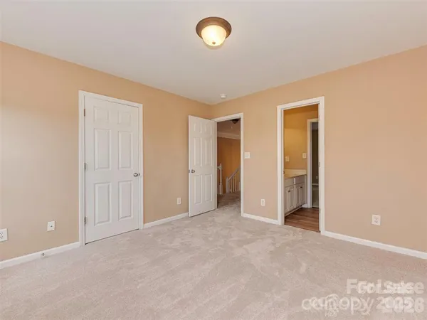 an empty room with fan and windows