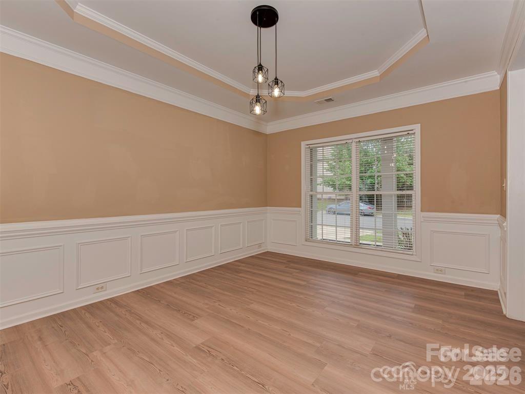 5607 Fulton Ridge Drive Indian Trail, NC 28079 - Photo 3 of 44 a view of an empty room with wooden floor and a window
