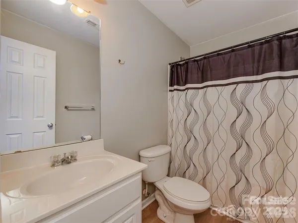 a bathroom with a sink and mirror with toilet