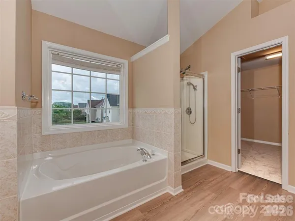 a bathroom with bathtub and a shower