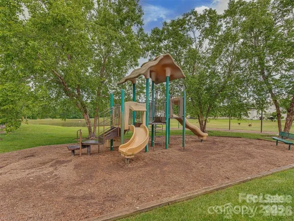 a view of a house with a backyard and a tree