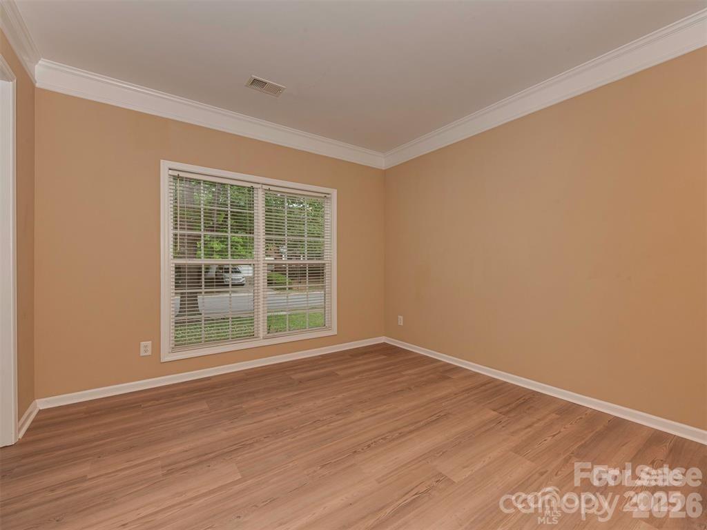 5607 Fulton Ridge Drive Indian Trail, NC 28079 - Photo 5 of 44 a view of an empty room with wooden floor and a window