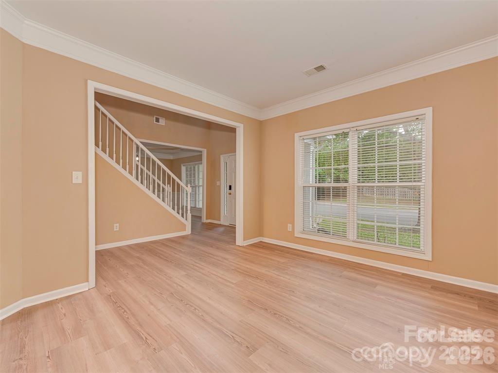 5607 Fulton Ridge Drive Indian Trail, NC 28079 - Photo 6 of 44 a view of an empty room with wooden floor and a window