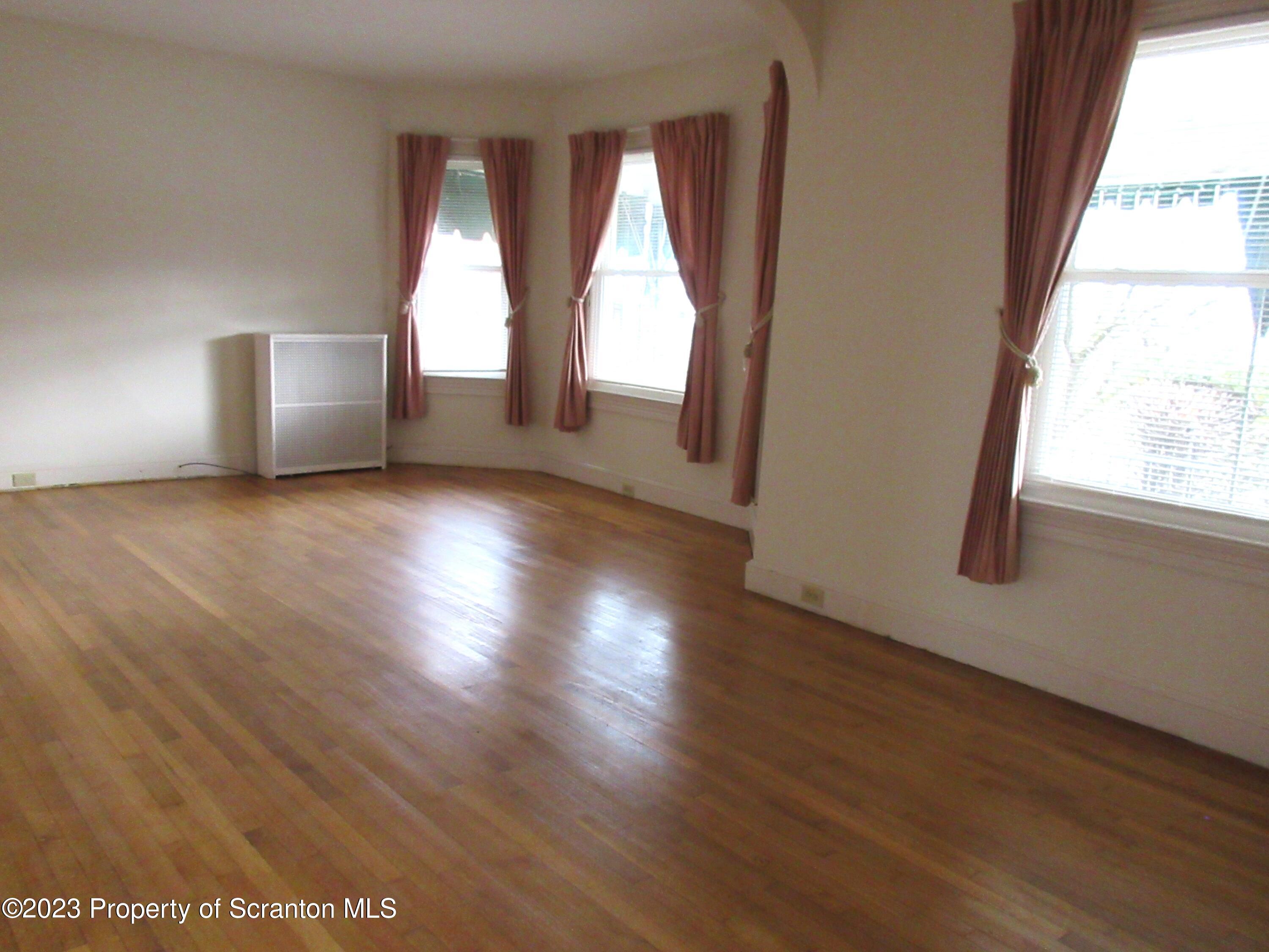 705 North Main Avenue Scranton, PA 18504 - Photo 14 of 25 a view of empty room with wooden floor and fan