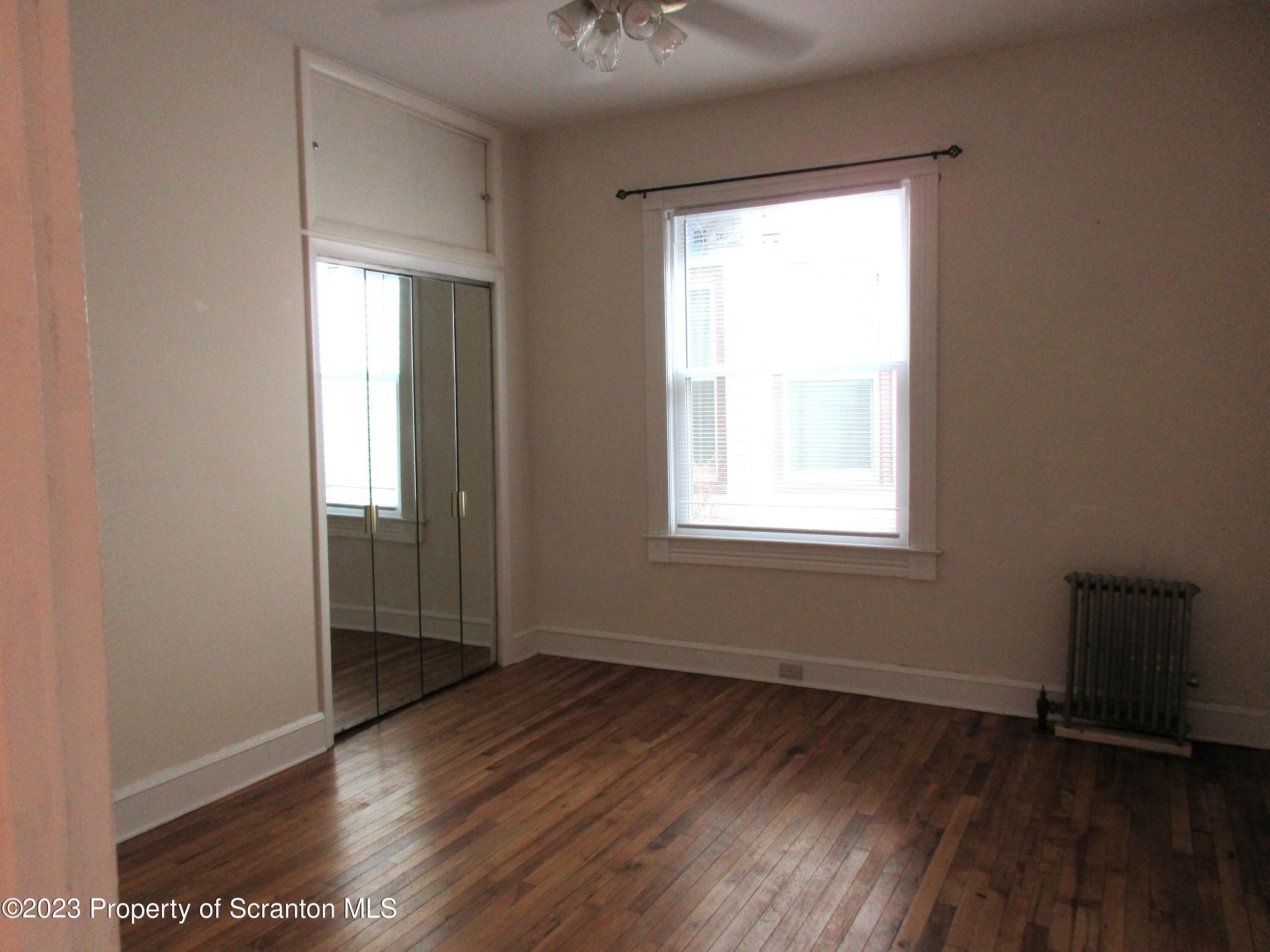 705 North Main Avenue Scranton, PA 18504 - Photo 16 of 25 an empty room with wooden floor and windows