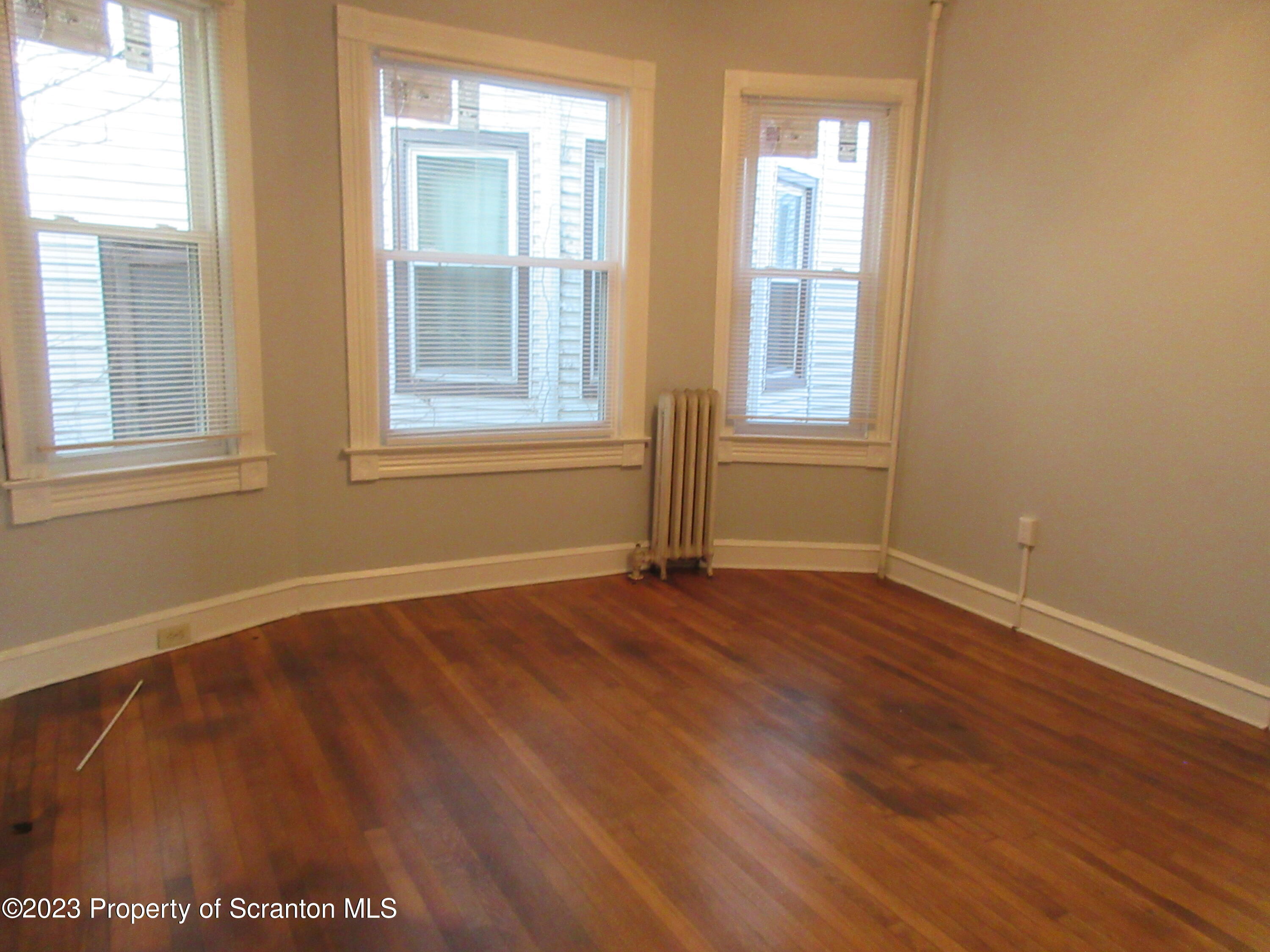 705 North Main Avenue Scranton, PA 18504 - Photo 18 of 25 a view of an empty room with wooden floor and a window