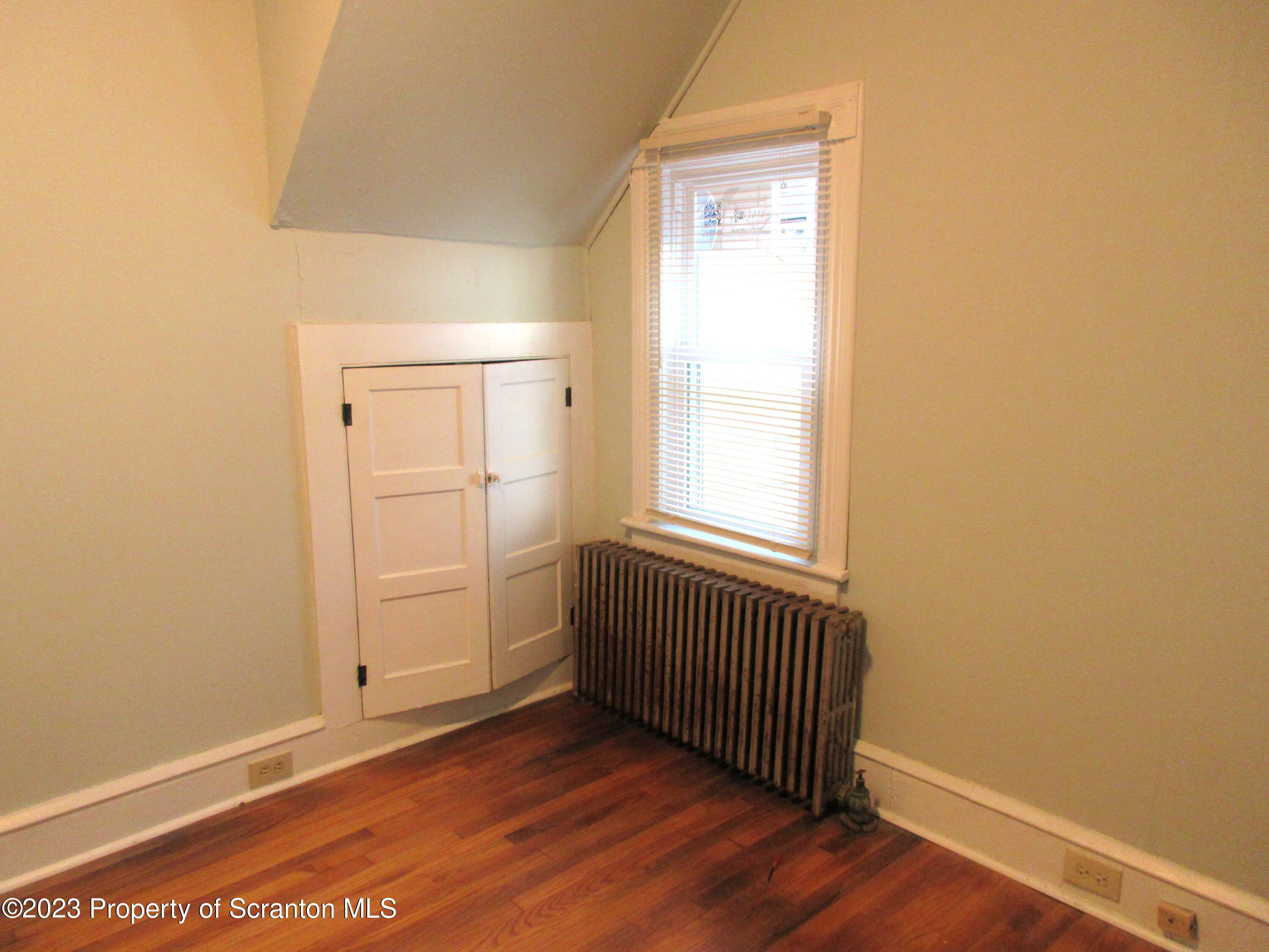 705 North Main Avenue Scranton, PA 18504 - Photo 21 of 25 an empty room with wooden floor and windows