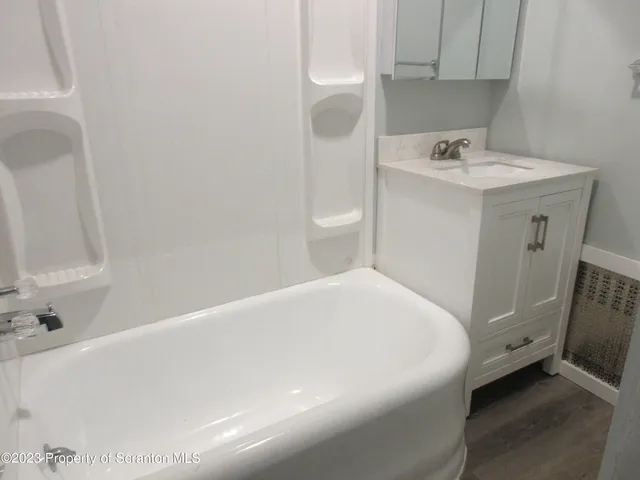 a white toilet sitting next to a bathroom sink