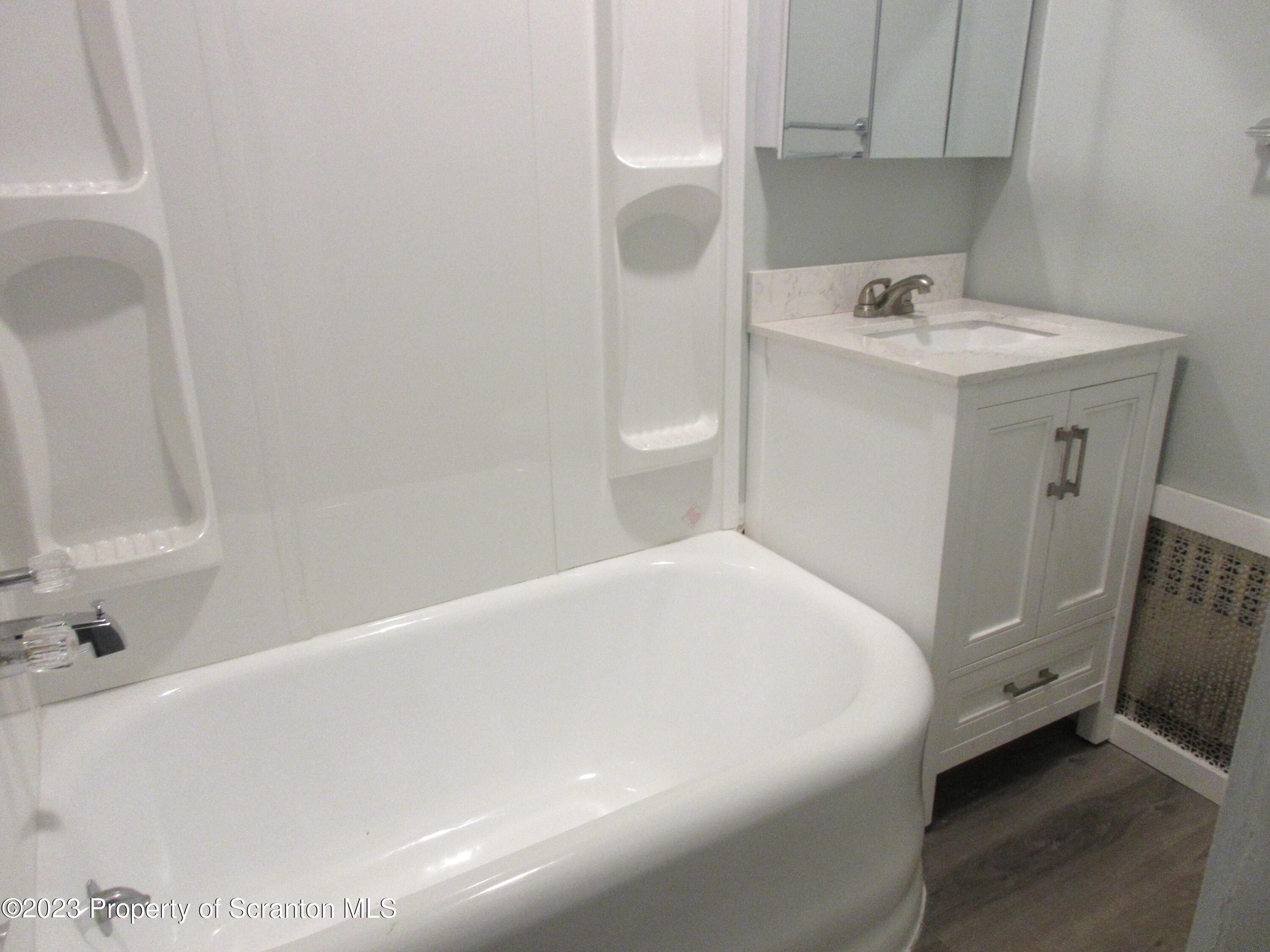 705 North Main Avenue Scranton, PA 18504 - Photo 22 of 25 a bathroom with a sink a toilet and shower