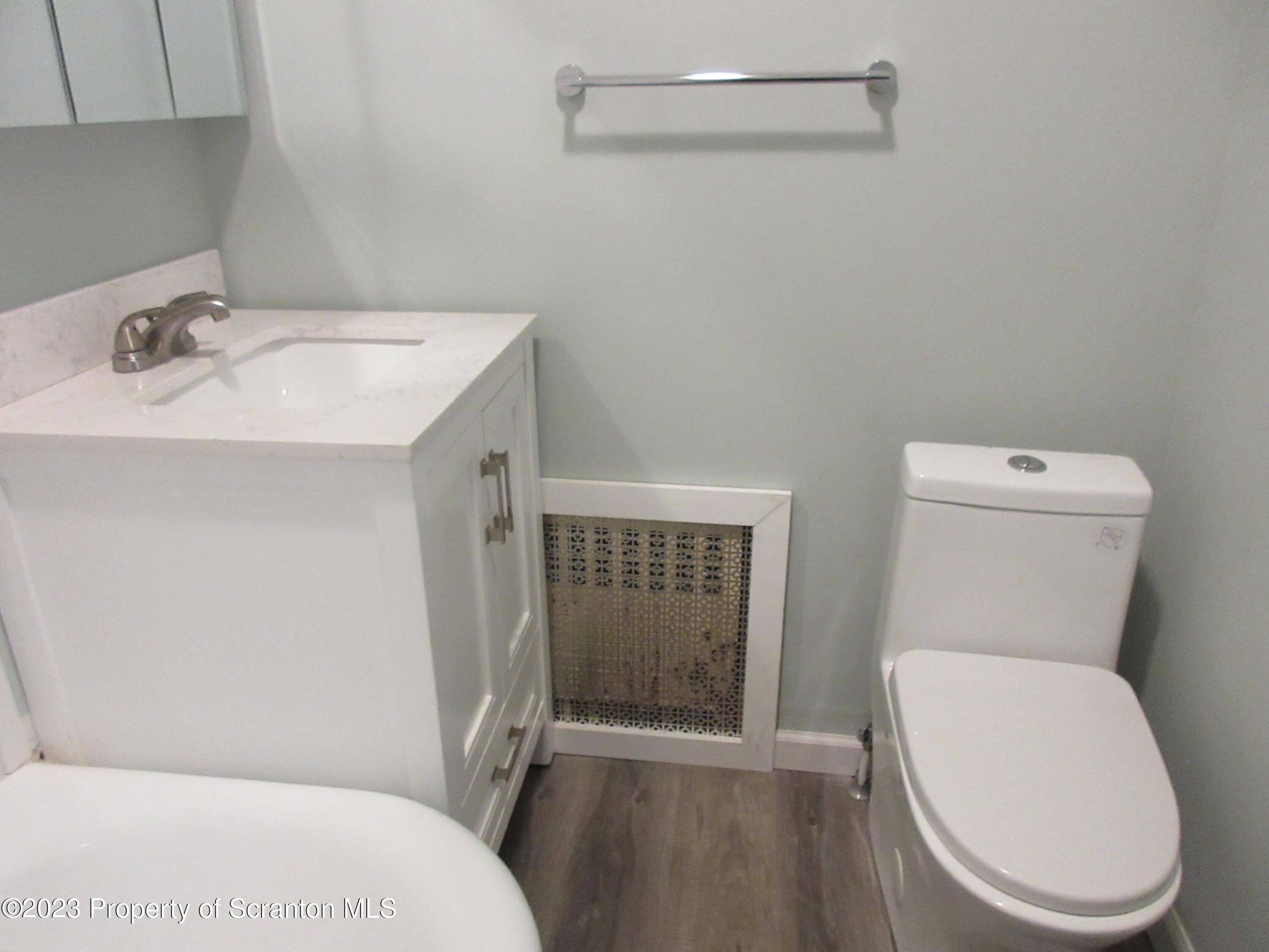 705 North Main Avenue Scranton, PA 18504 - Photo 23 of 25 a white toilet sitting next to a bathroom sink