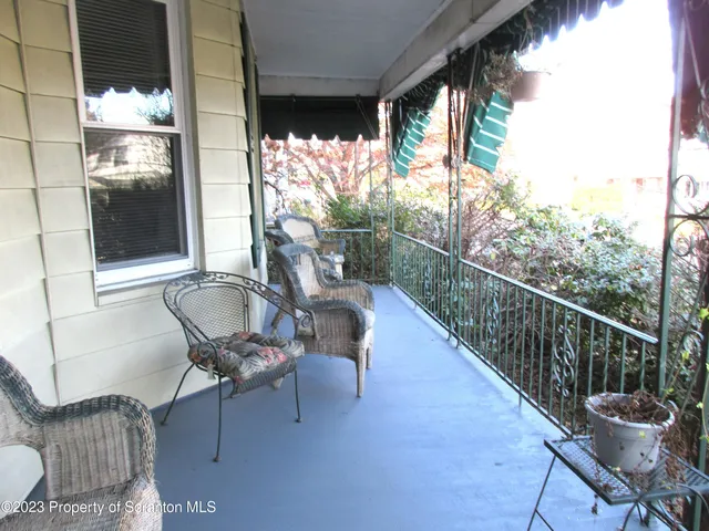 a view of a chair and table in the balcony