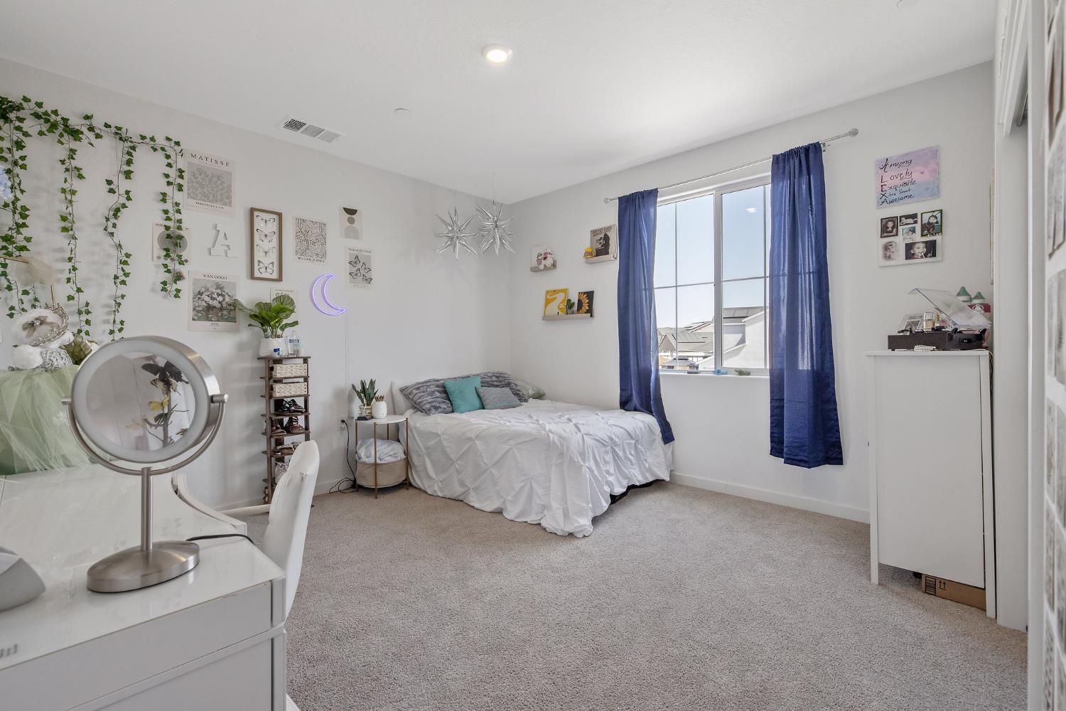 2409 Pepperdine Street Lemoore, CA 93245 - Photo 19 of 50 a spacious bedroom with a bed and ceiling fan