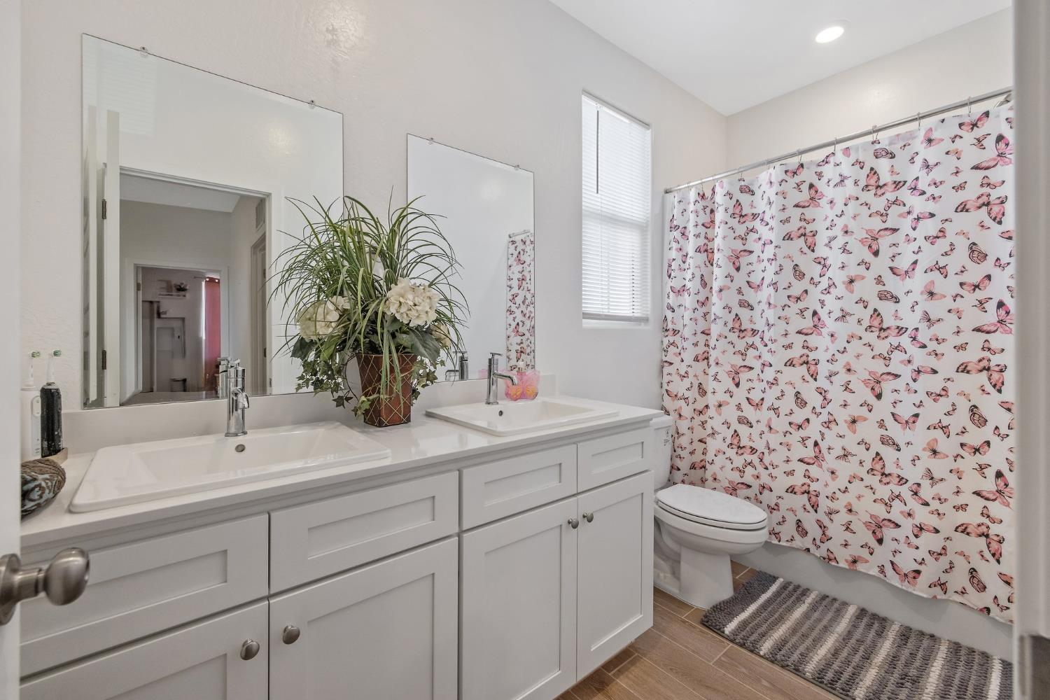 2409 Pepperdine Street Lemoore, CA 93245 - Photo 20 of 50 a bathroom with a sink a toilet and a mirror