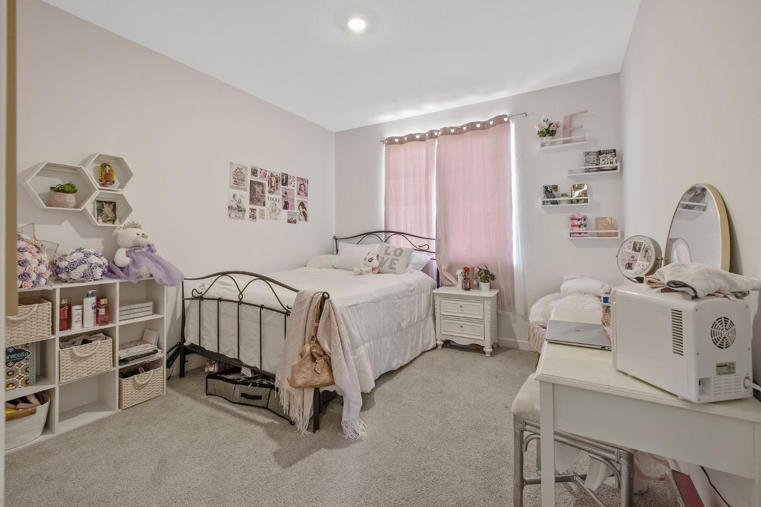 2409 Pepperdine Street Lemoore, CA 93245 - Photo 22 of 50 a spacious bedroom with a bed a couch and a window