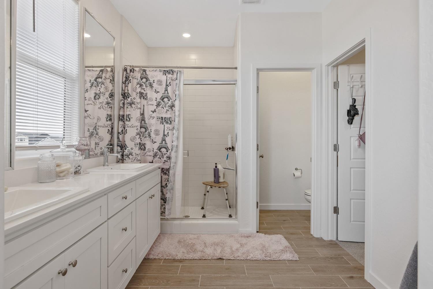 2409 Pepperdine Street Lemoore, CA 93245 - Photo 26 of 50 a spacious bathroom with a shower sink and mirror