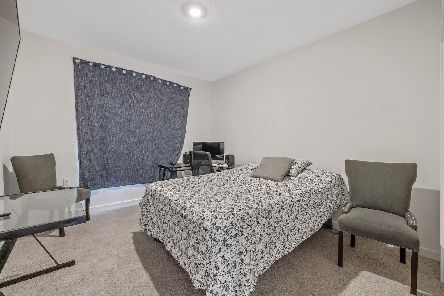 2409 Pepperdine Street Lemoore, CA 93245 - Photo 35 of 50 a bedroom with a bed and chair