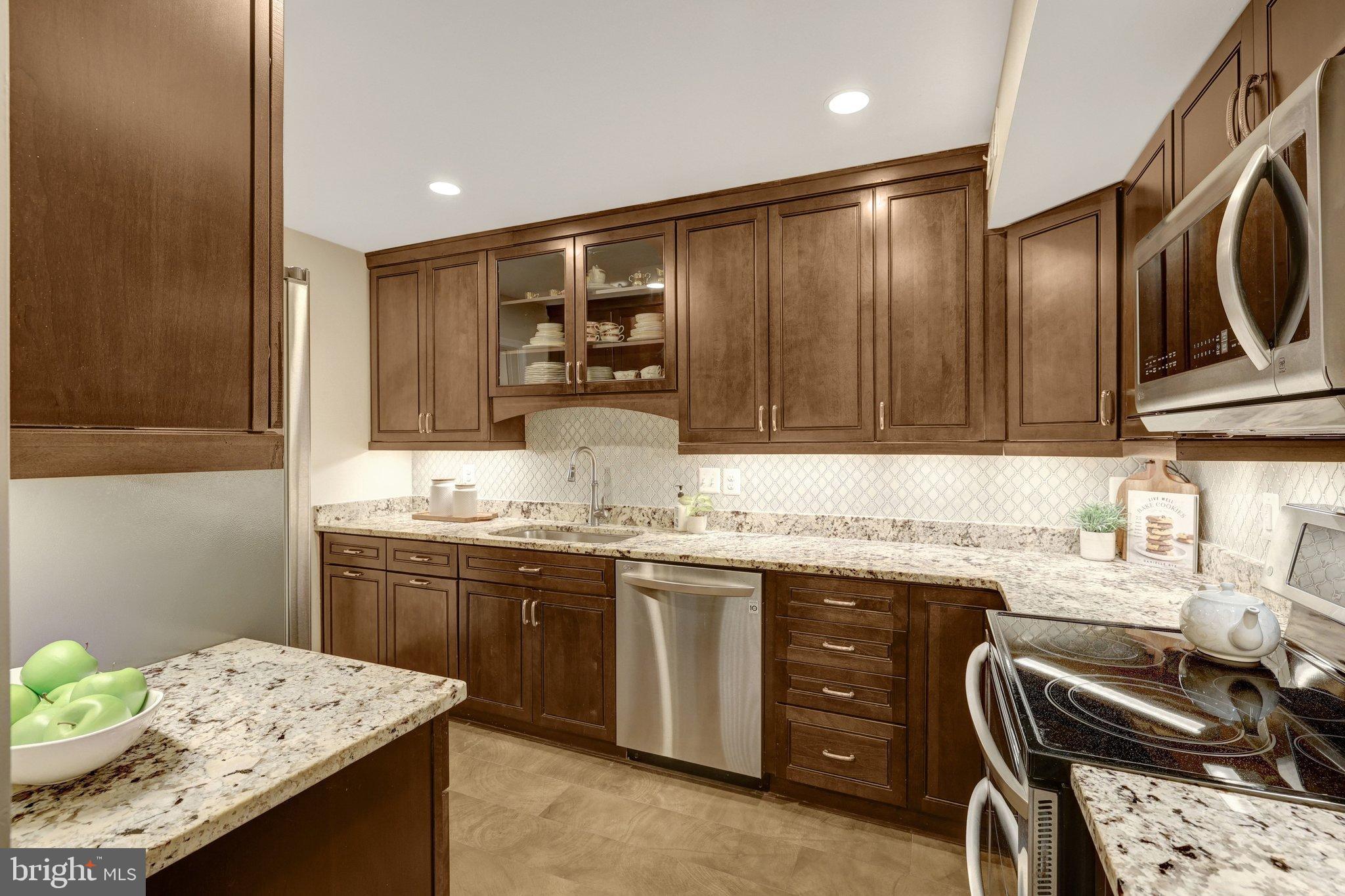 1008 Moore Place Southwest Vienna, VA 22180 - Photo 18 of 55 a kitchen with a sink a stove and cabinets