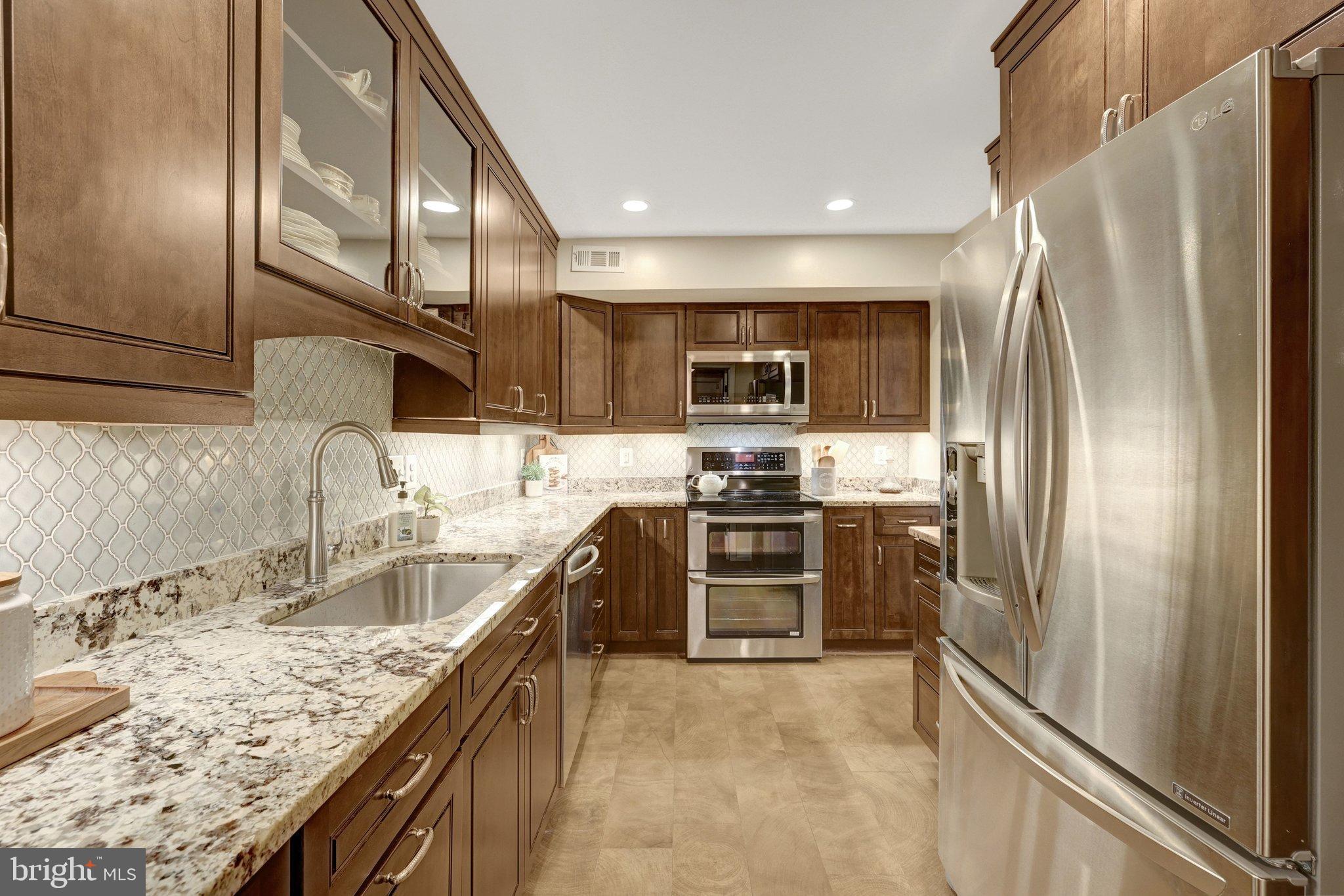 1008 Moore Place Southwest Vienna, VA 22180 - Photo 20 of 55 a kitchen with stainless steel appliances granite countertop a refrigerator and a stove