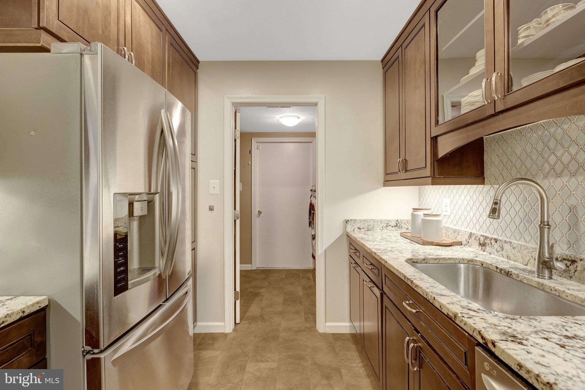 1008 Moore Place Southwest Vienna, VA 22180 - Photo 21 of 55 a kitchen with stainless steel appliances granite countertop a sink stove and refrigerator