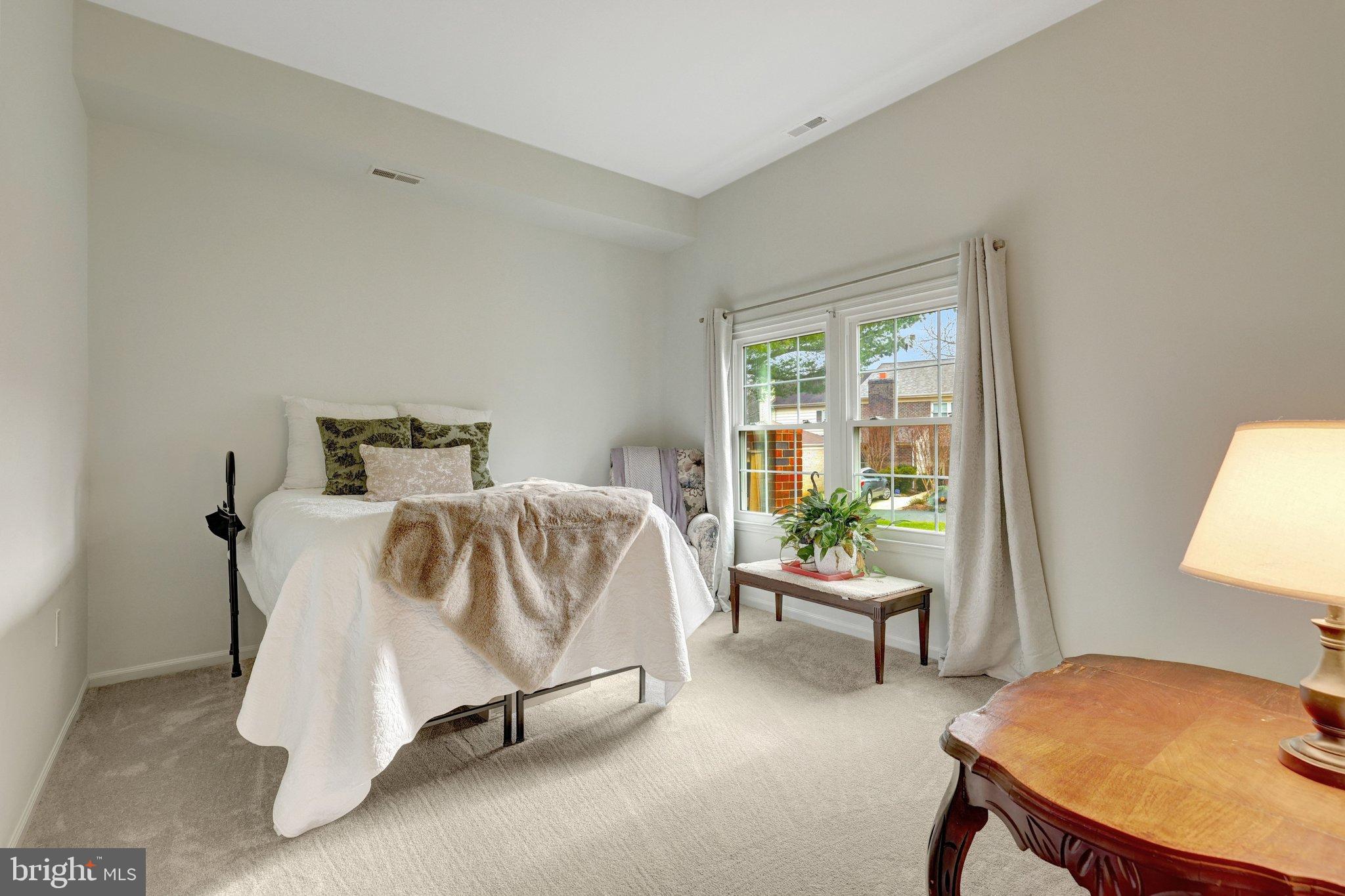 1008 Moore Place Southwest Vienna, VA 22180 - Photo 24 of 55 a bedroom with a bed and table lamp