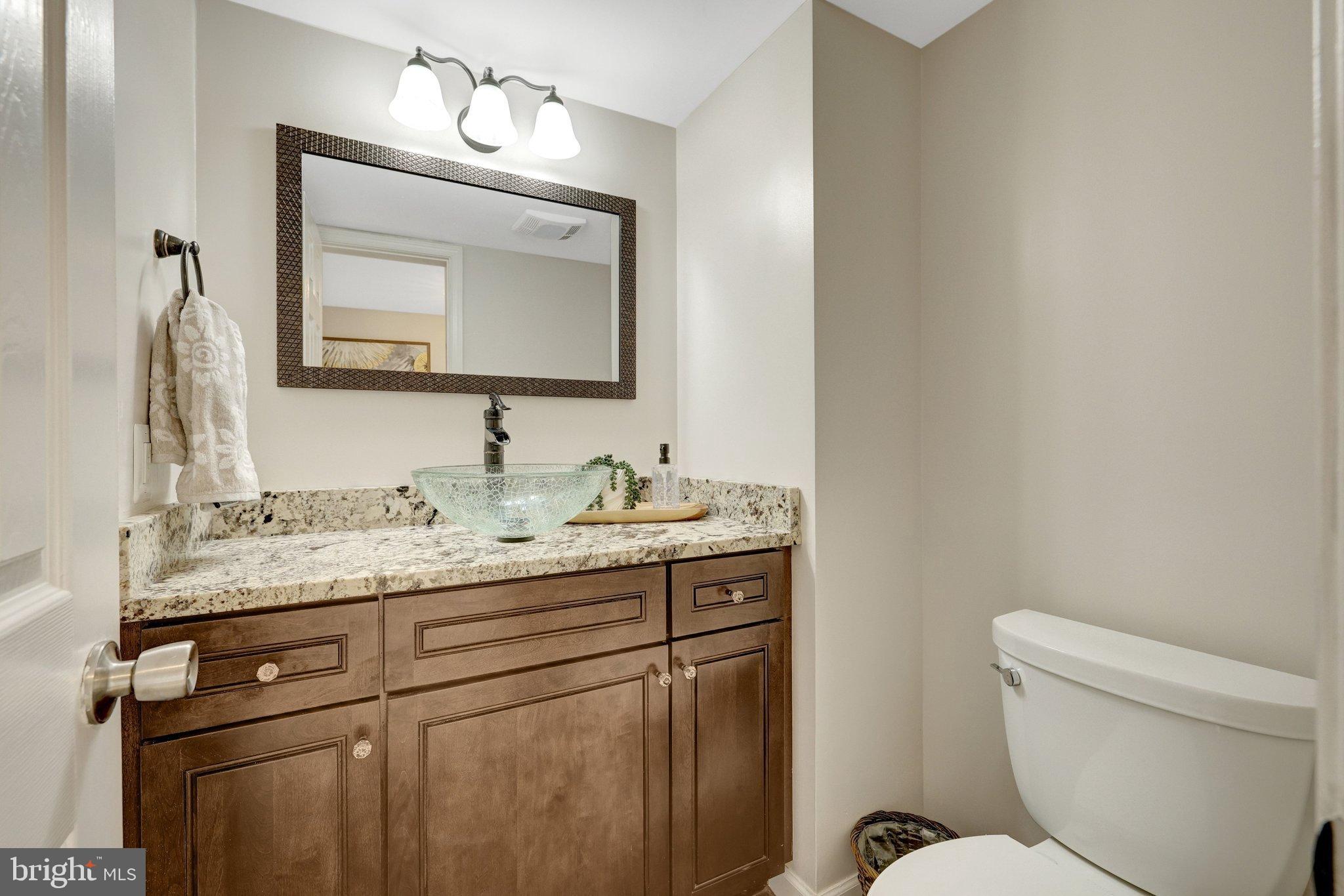 1008 Moore Place Southwest Vienna, VA 22180 - Photo 26 of 55 a bathroom with a toilet sink and mirror