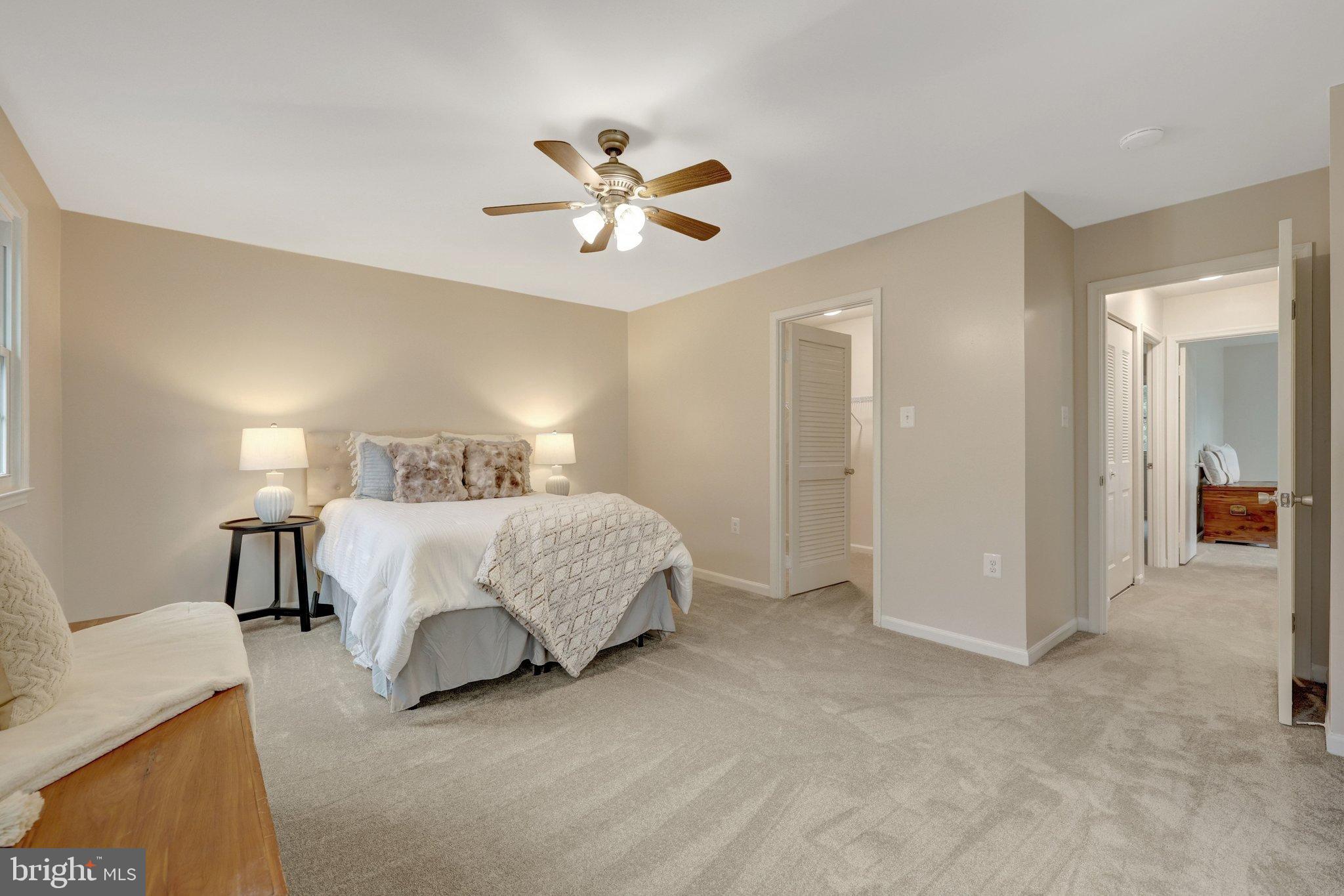 1008 Moore Place Southwest Vienna, VA 22180 - Photo 30 of 55 a spacious bedroom with a bed and a chandelier