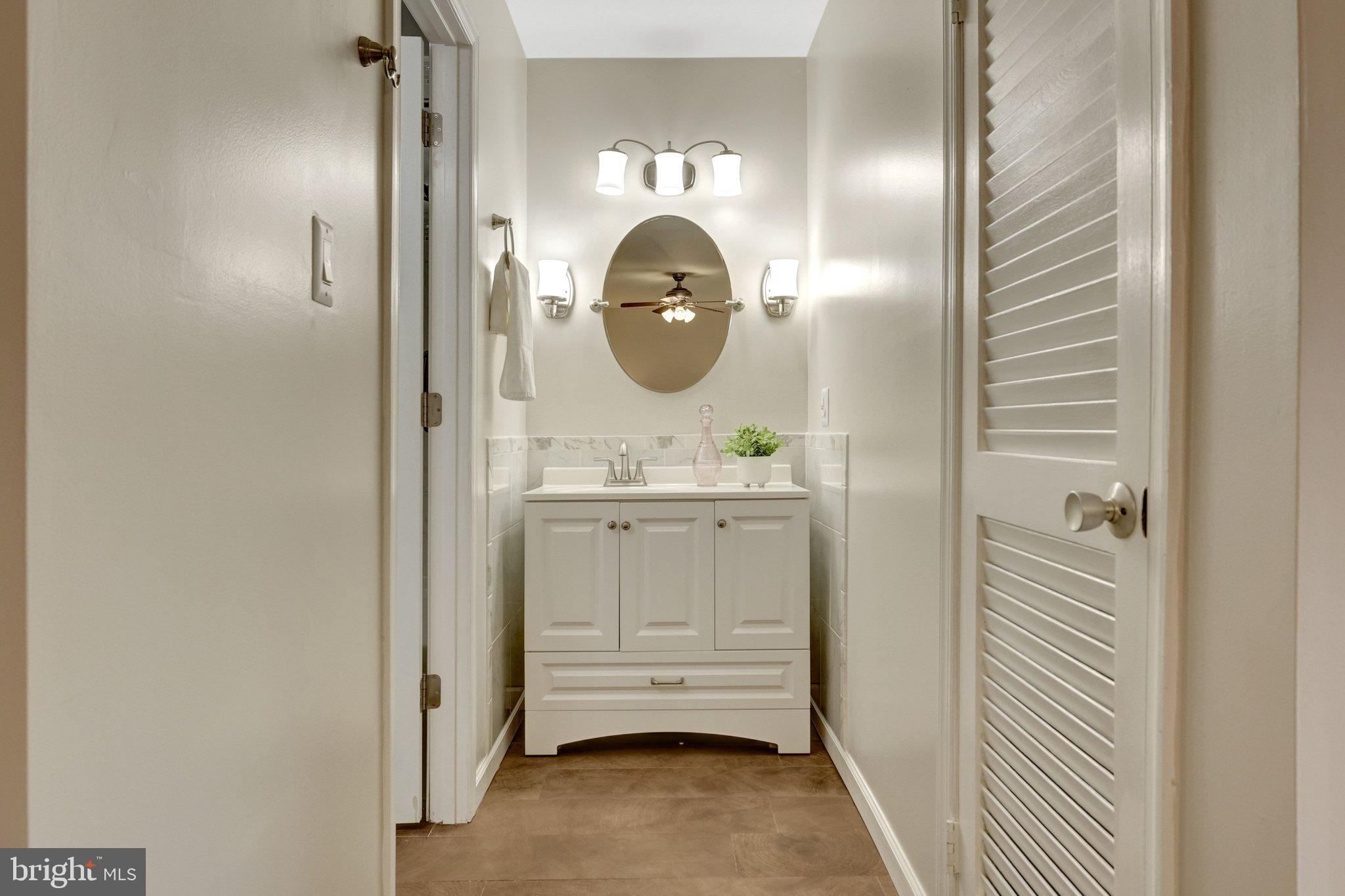 1008 Moore Place Southwest Vienna, VA 22180 - Photo 35 of 55 a bathroom with a sink and a mirror