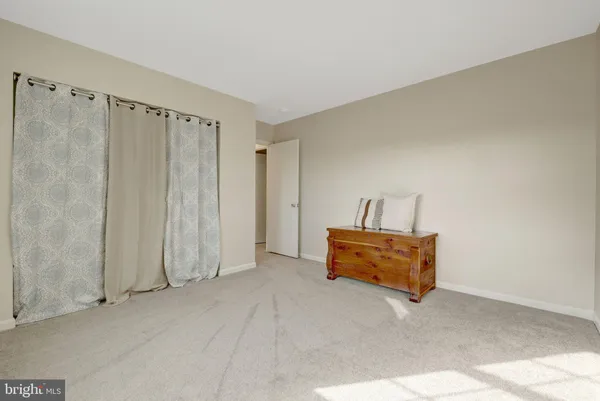 a bedroom with bed and a window