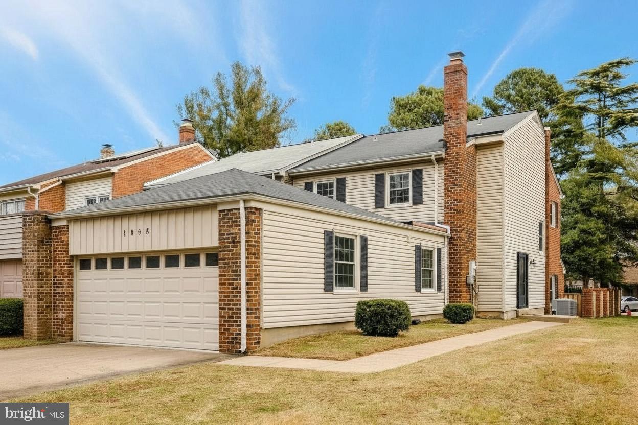 1008 Moore Place Southwest Vienna, VA 22180 - Photo 4 of 55 a front view of a house with a yard