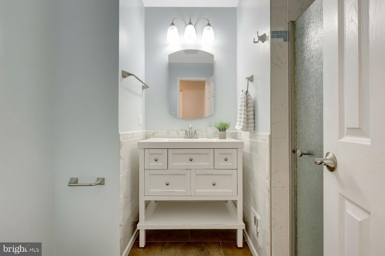 1008 Moore Place Southwest Vienna, VA 22180 - Photo 44 of 55 a bathroom with a sink and a mirror