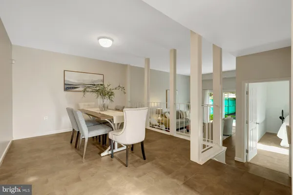 a dining room with table and chairs