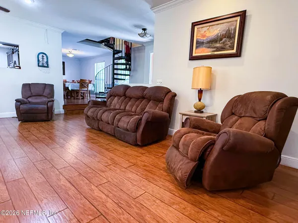 a living room with couches and painting on the wall