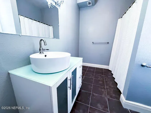 a bathroom with a sink and a mirror
