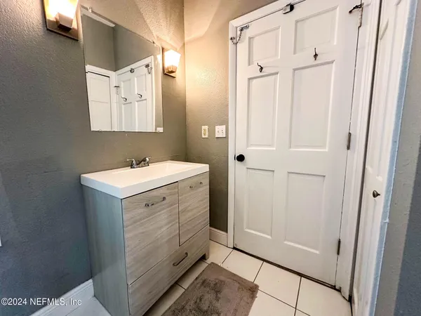 a bathroom with a sink mirror and vanity