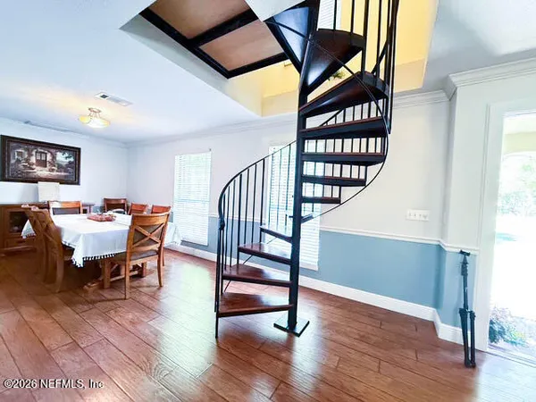 a view of a livingroom with furniture and hardwood floor