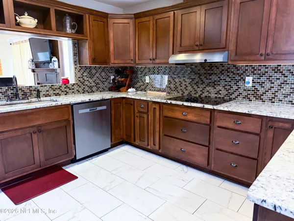 a kitchen with stainless steel appliances granite countertop cabinets and wooden floor