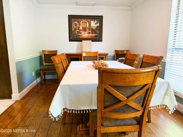 a living room with furniture a rug and a wooden floor