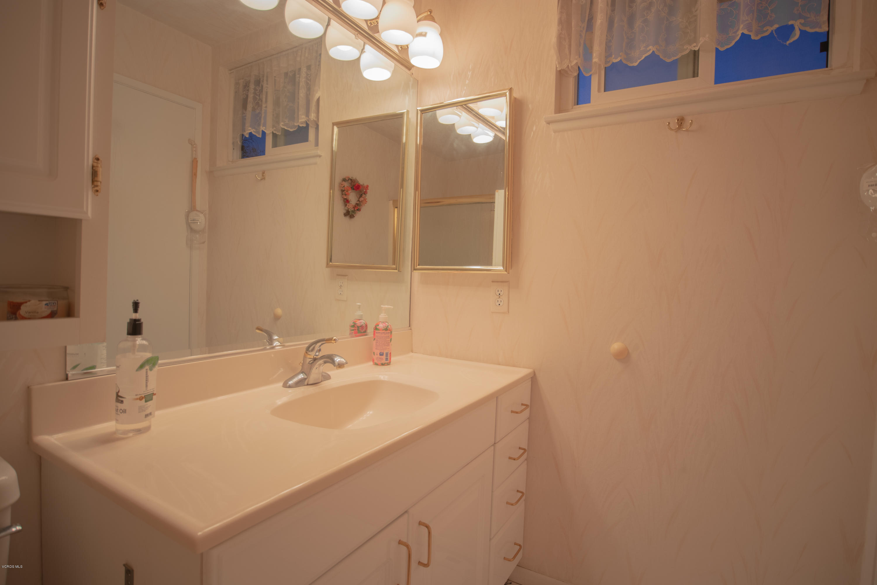 1113 Waltham Road Simi Valley, CA 93065 - Photo 14 of 20 a bathroom with a sink a mirror and a shower