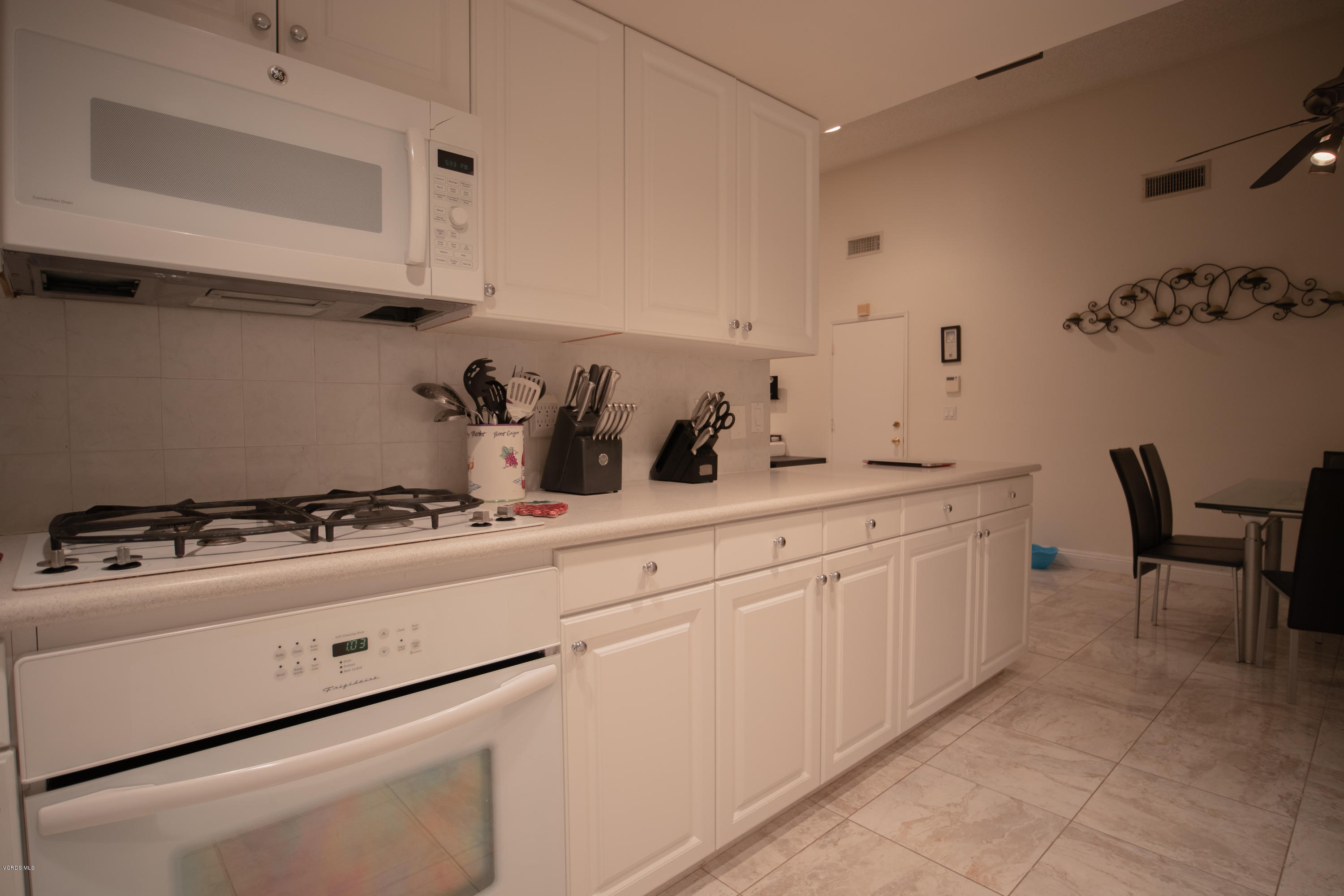1113 Waltham Road Simi Valley, CA 93065 - Photo 6 of 20 a kitchen with white cabinets and white appliances