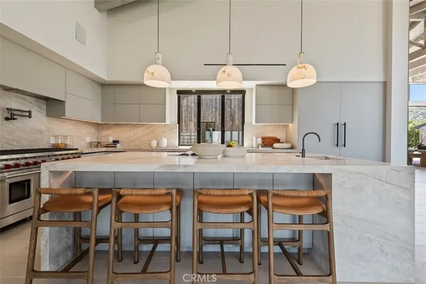 a kitchen with cabinets and chairs