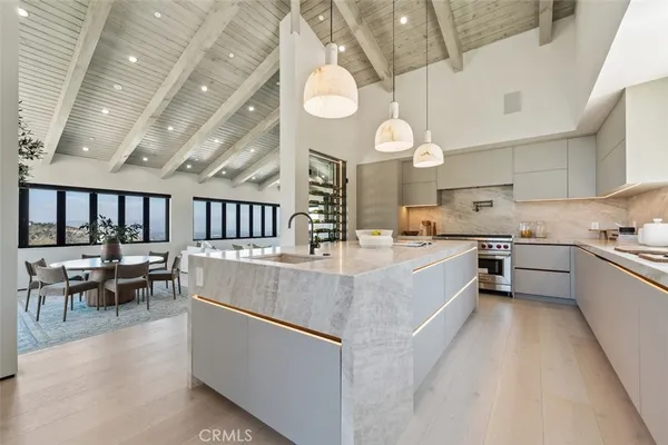 a large kitchen with a large window and stainless steel appliances