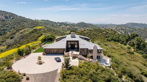 a view of a house with a mountain in the background