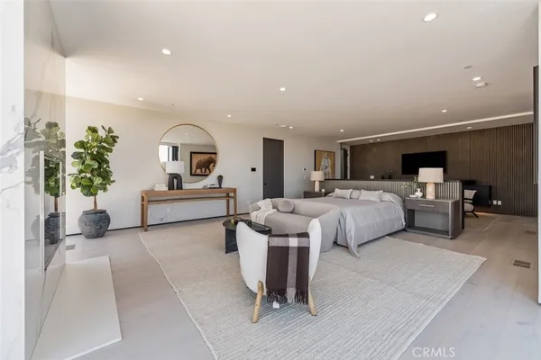 a spacious bedroom with a bed and a large window