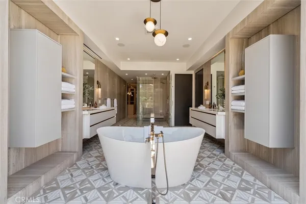 a large living room with stainless steel appliances furniture cabinets and a rug