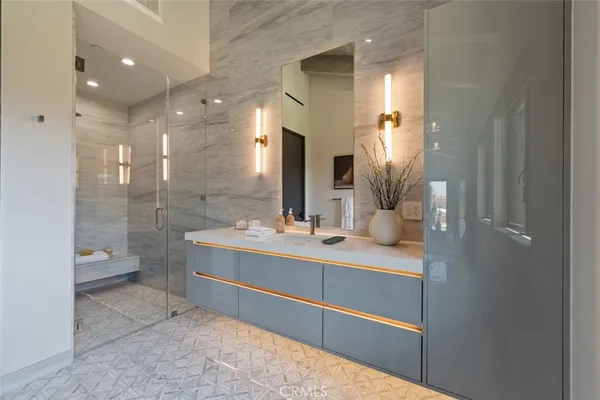 a bathroom with a double vanity sink mirror and shower